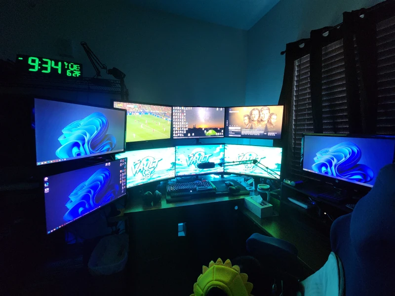 Three computers split across distinct jobs here: a main PC for general use, a work machine, and a third dedicated to staffing a FiveM community called The Vault RP, where monitoring city logs and helping on Discord stays on its own screens.