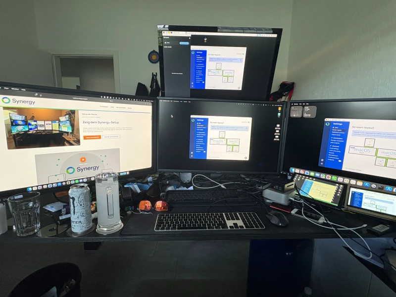 Two Mac minis sit at the core here: one for daily work, one kept aside purely for testing. A Raspberry Pi 5 overhead handles calls and scheduling displays, while a second Pi handles Flutter frontend and PostgreSQL backend development.