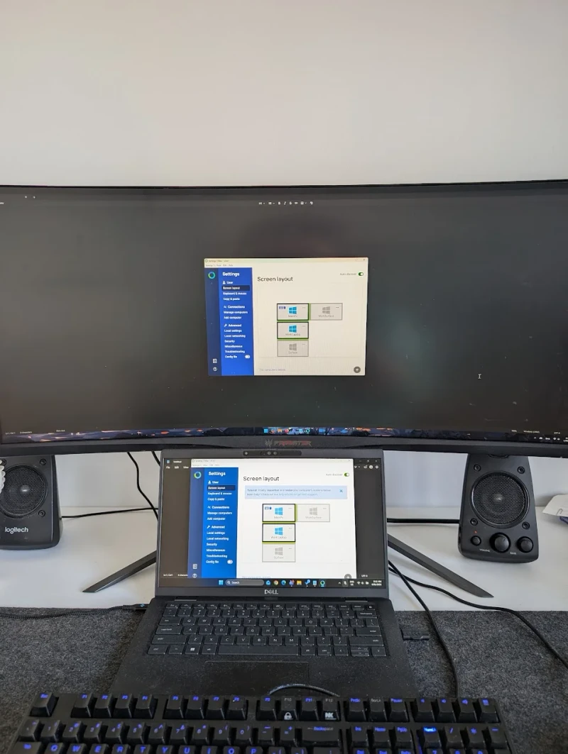 Synergy ties together a main desktop PC and three other devices, all running from one keyboard and mouse. Both machines shown here have the Screen layout panel open, suggesting the setup was freshly configured and working flawlessly from the start.