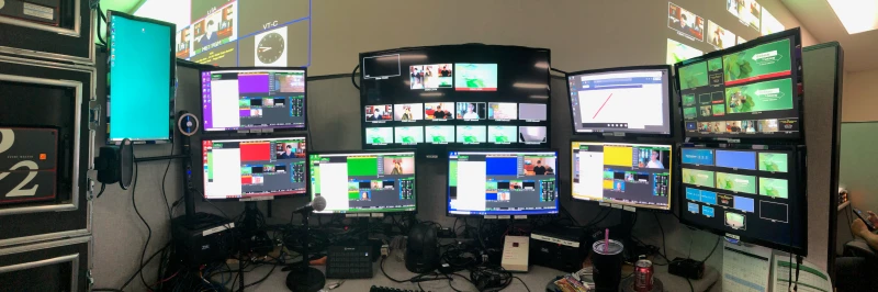 During COVID, this op station tracked up to 12 discrete remote callers live from a single seat, with seven PCs running simultaneously. Synergy let one keyboard and mouse move across all of them, keeping the whole production reachable without ever leaving the chair.