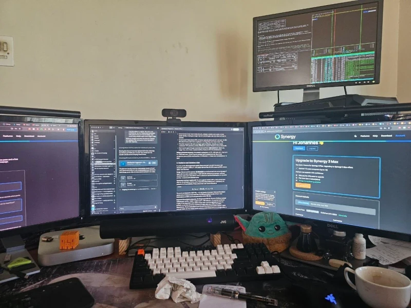 Serious research and work is the stated purpose, and the open documents back that up. Synergy ties the machines together so one keyboard and mouse reaches everything on the desk without interruption, keeping focus on the work rather than the inputs.