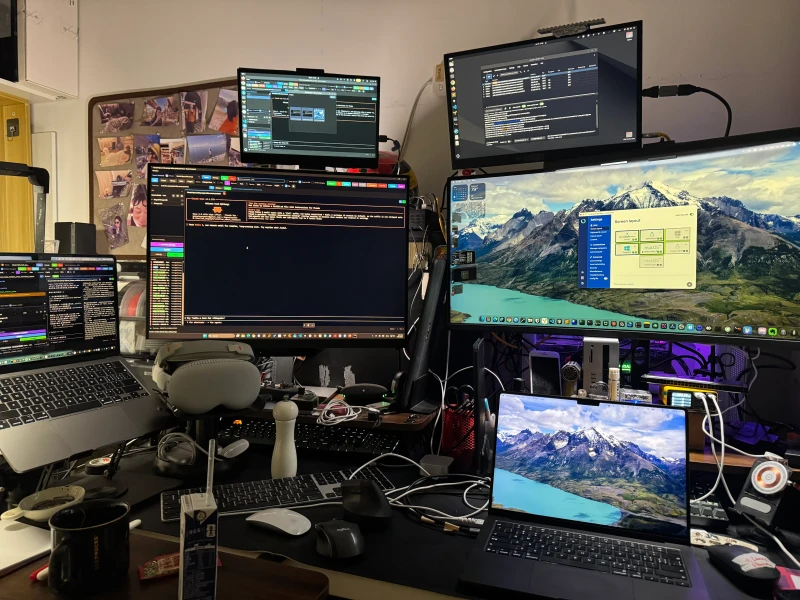 Five machines across three operating systems, two Macs, two Linux boxes, and a Windows machine, all sharing one keyboard and mouse. Synergy keeps everything reachable from the same spot without swapping inputs between them.