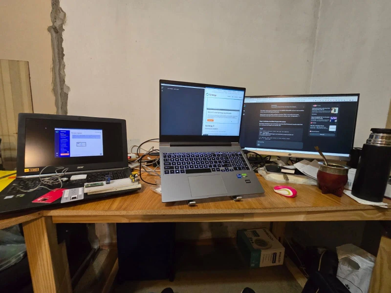 Four Linux machines spanning a decade of hardware, from a 2014 laptop to a brand-new one, share a single mouse and keyboard to run a distributed fullstack and LLM agent development environment. The goal is no interruptions and no failures, whether working from home or the lab.