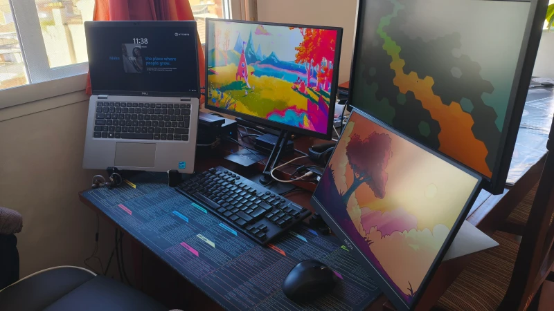 Jumping between a locked-down corporate Windows laptop and a full Linux development stack on the same desk is where this setup earns its keep. Synergy handles the handoff with one keyboard and mouse centered on the desk mat, so switching environments mid-task takes no effort at all.