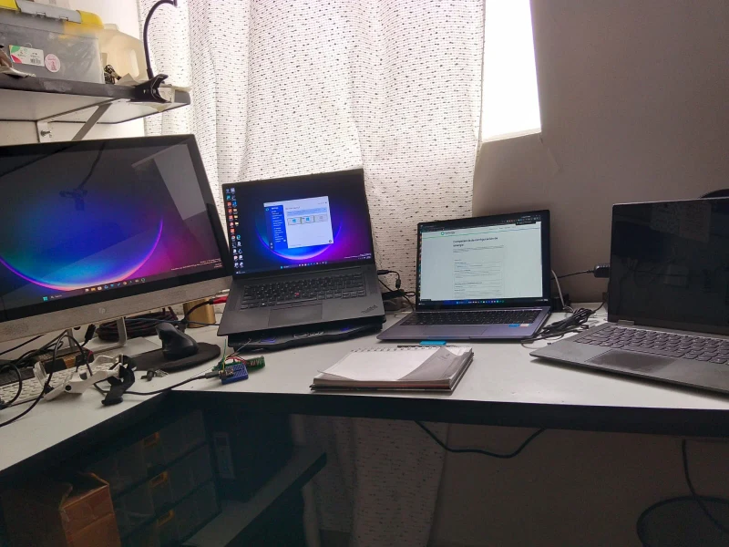 Three Windows machines sharing one keyboard and mouse for embedded systems design and programming. The cursor moves freely between them, which keeps coding, testing, and design work on separate machines without the need to swap inputs.