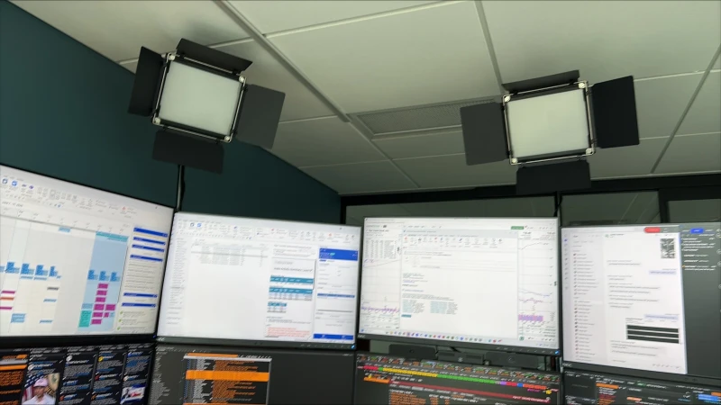 Running Windows across what looks like a busy production or trading environment, with project schedules, data tables, and code visible across multiple machines. Synergy keeps one keyboard and mouse moving between them all without interruption.