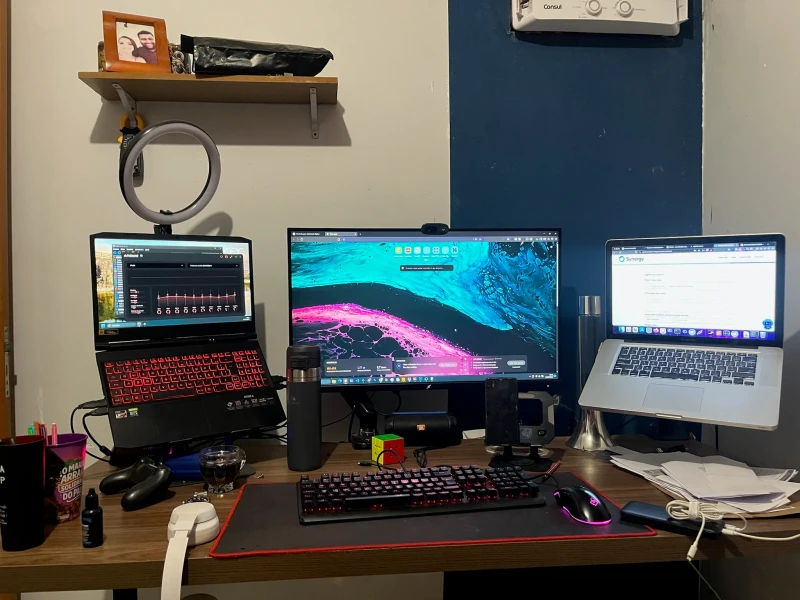 The MacBook Pro here is kept purely for AI processing, while the Acer Nitro 5 handles everything else. Synergy shares the Nitro's keyboard and mouse across both machines, so there's no swapping peripherals when work shifts between Windows and macOS.