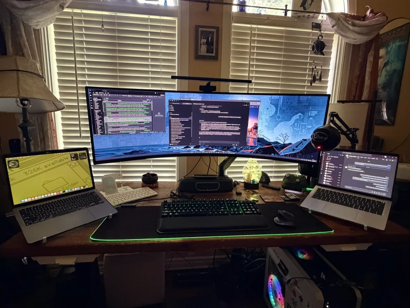 The G9 does split-screen duty between the gaming PC and either laptop, so any of the three machines can claim display space as needed. One keyboard and mouse covers all of them through Synergy, no input switching required.