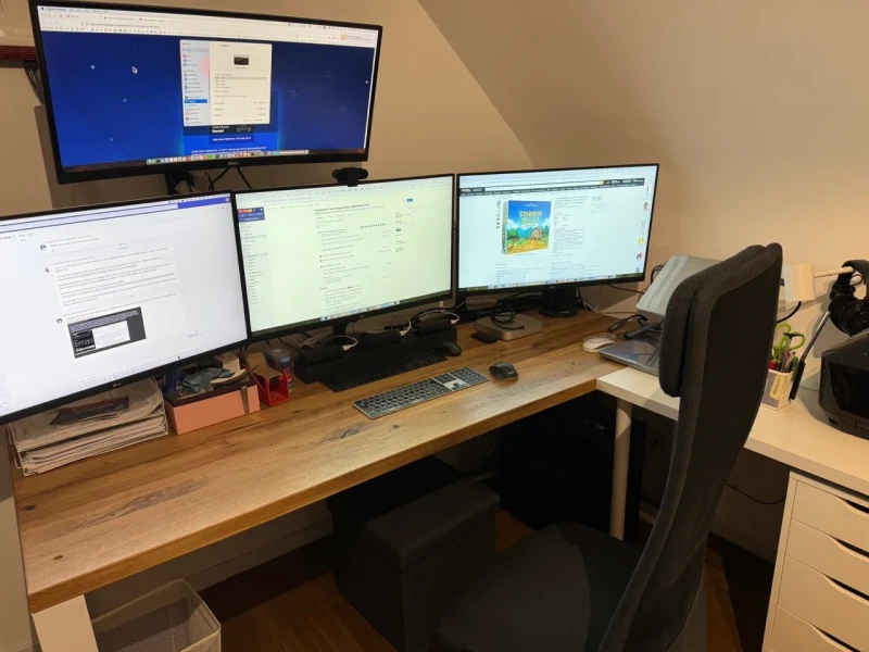 Four machines with distinct jobs: a work MacBook, a personal MacBook, a PC handling the heavier AI models and gaming, and a Mac Mini picking up parallel tasks.